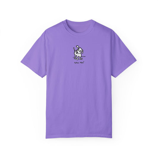 Violet colored t-shirt featuring a small, centered linocut-style illustration of a cartoon dog with a raised ear and tilted head, standing above the caption “Who Me?”