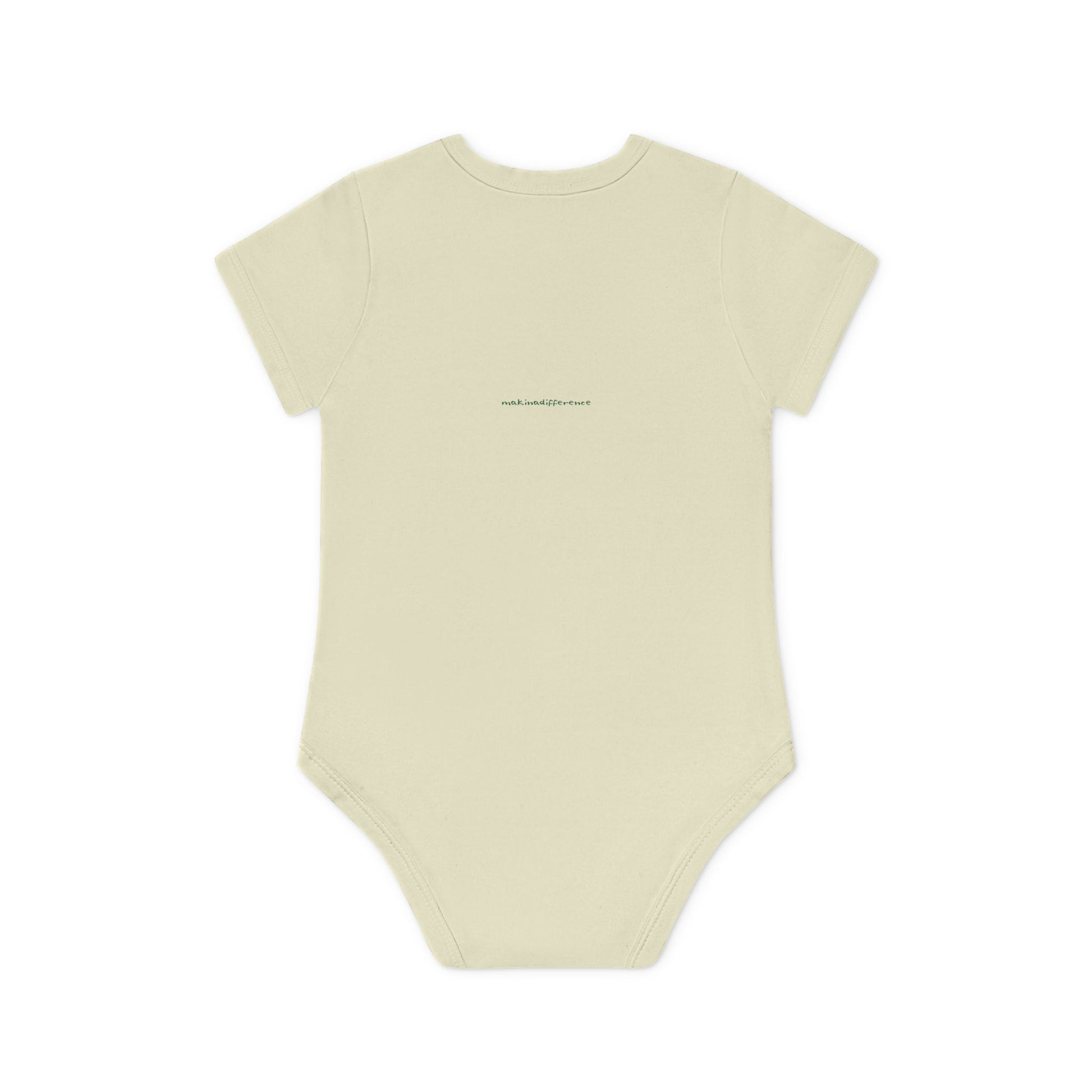 Off white baby onesie viewed from the back, featuring small, centered text near the upper back that reads "makinadifference.net" in a simple, dark font.