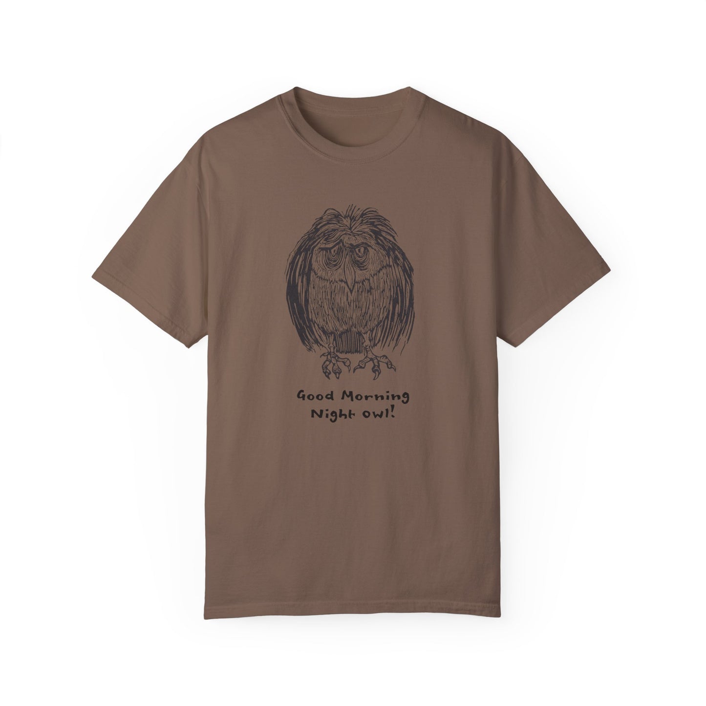 Brown or coffee colored t-shirt featuring an illustration of a tired-looking owl with messy feathers, created from a linoleum block print. The owl stands with drooping eyes, and below it, the text reads: “Good Morning Night Owl!