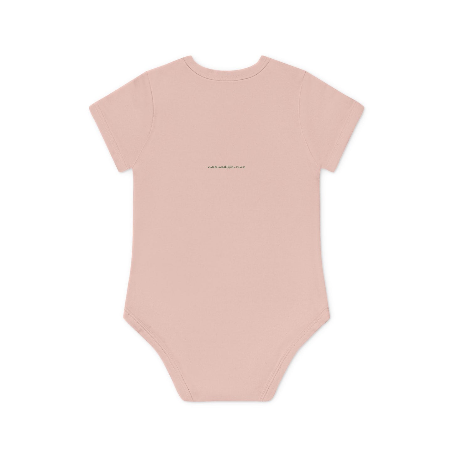 Light pink baby onesie viewed from the back, featuring small, centered text near the upper back that reads "makinadifference.net" in a simple, dark font.