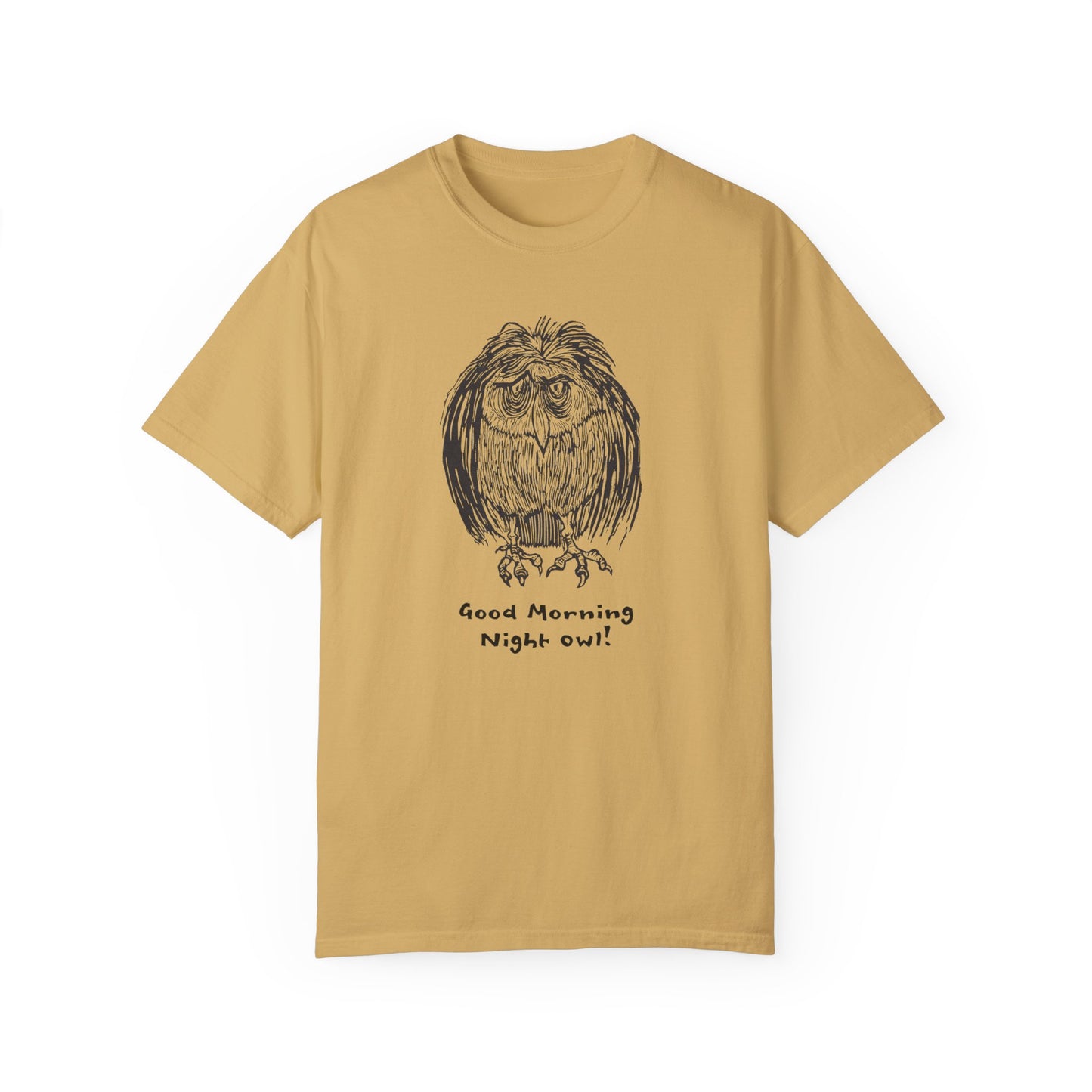 Golden yellow colored t-shirt featuring an illustration of a tired-looking owl with messy feathers, created from a linoleum block print. The owl stands with drooping eyes, and below it, the text reads: “Good Morning Night Owl!
