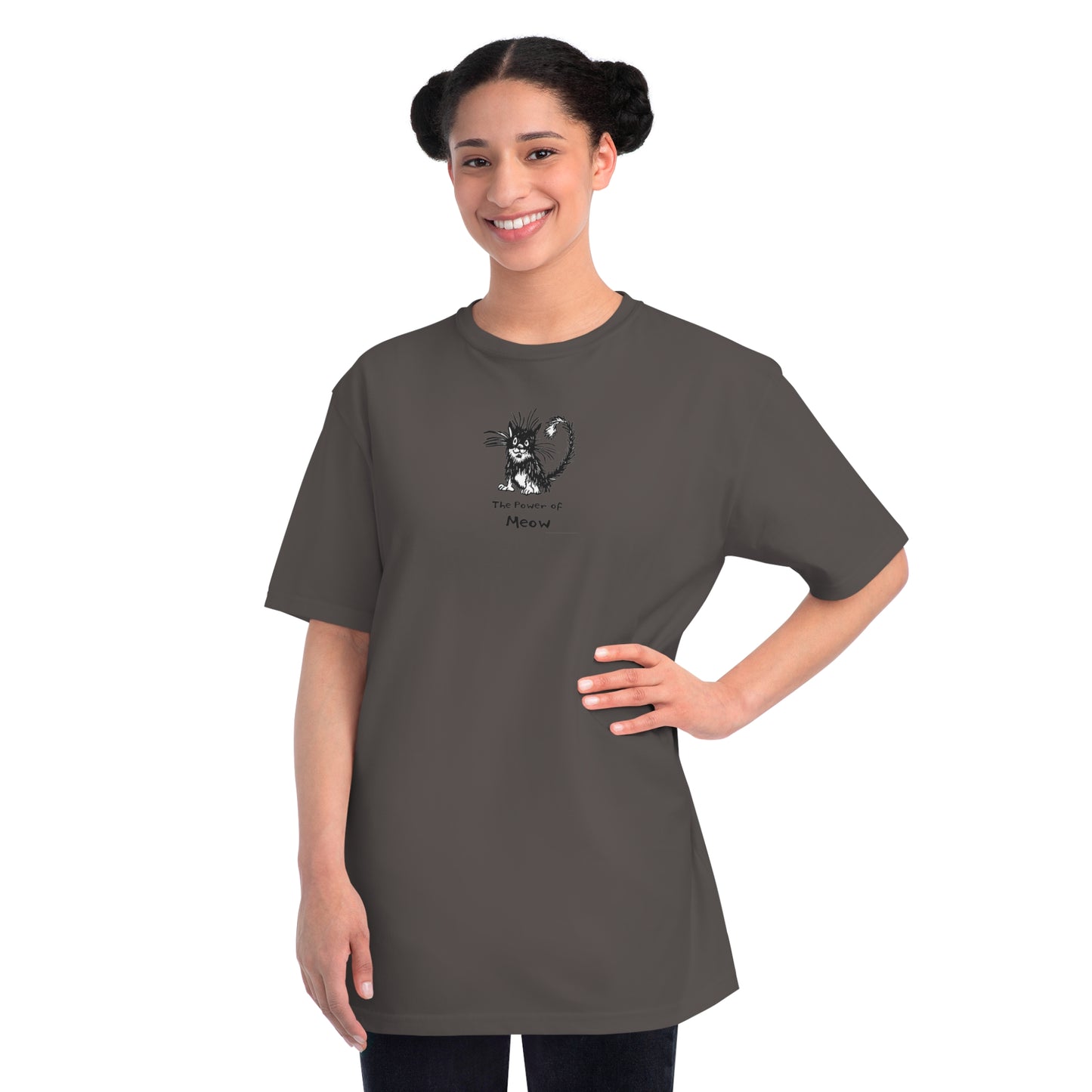 Woman standing wearing charcoal gray organic unisex t-shirt featuring a humorous cartoon cat design with the text “The Power of Meow,” perfect for cat lovers.