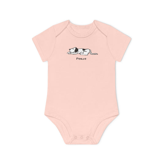 Light pink short sleeve onesie baby bodysuit featuring a simple black and white illustration of a sleeping dog above the word "Peace" printed on the chest.