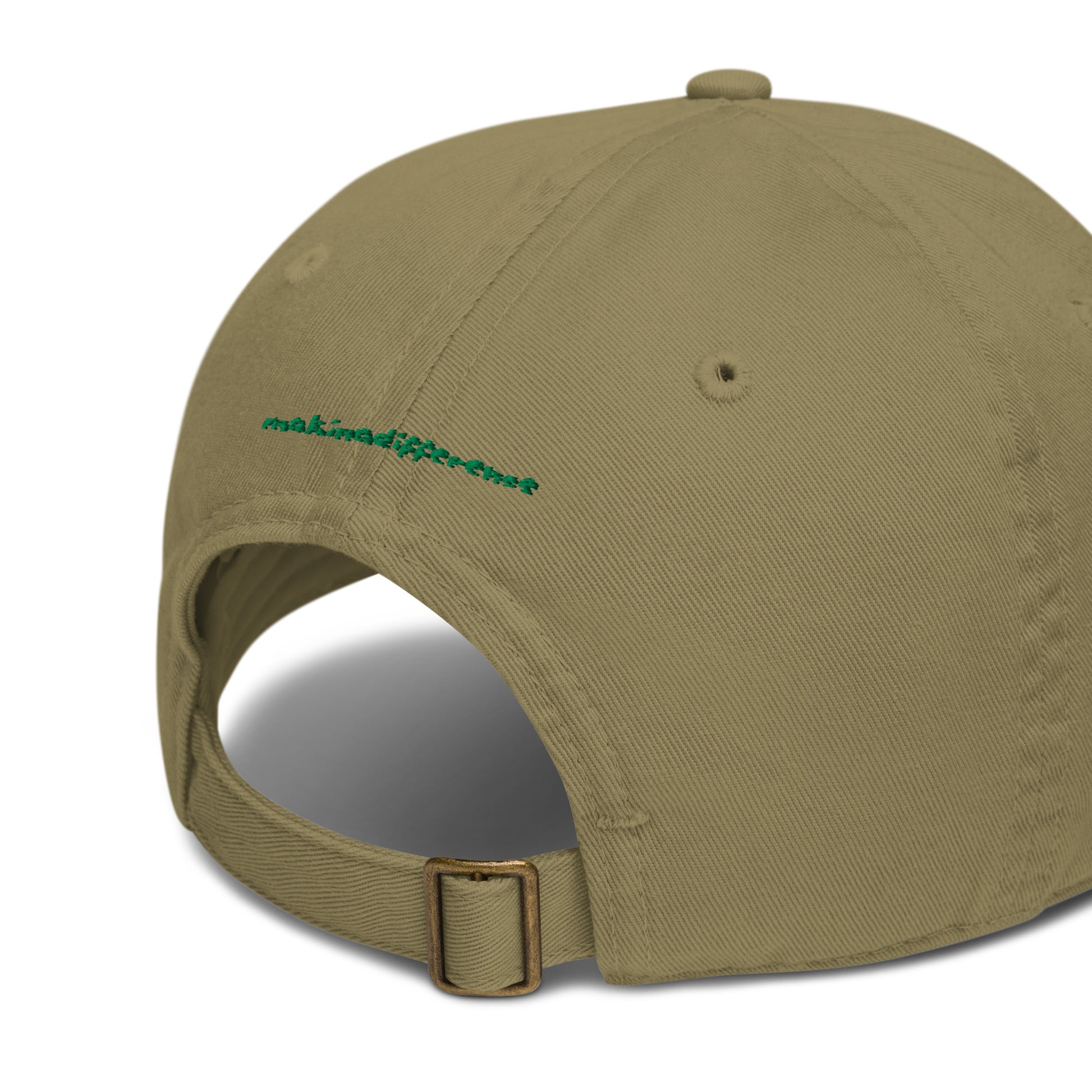 Rear view of a jungle green colored baseball cap featuring an adjustable brass buckle strap and small green embroidered text that reads "makinadifference" above the opening.