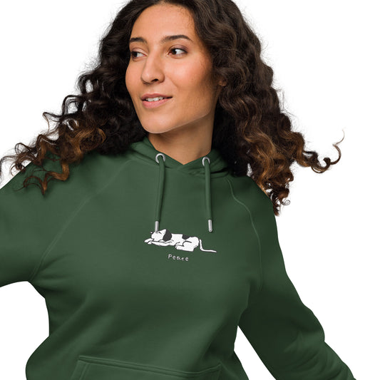 Woman wearing a dark green hoodie featuring a black and white illustration of dog lying down with its eyes closed.  The word “Peace” printed beneath the design.