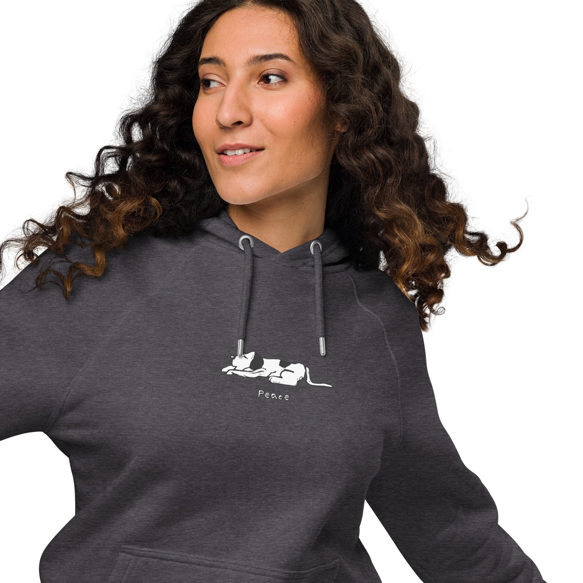 Woman wearing a charcoal hoodie featuring a black and white illustration of dog lying down with its eyes closed.  The word “Peace” printed beneath the design.