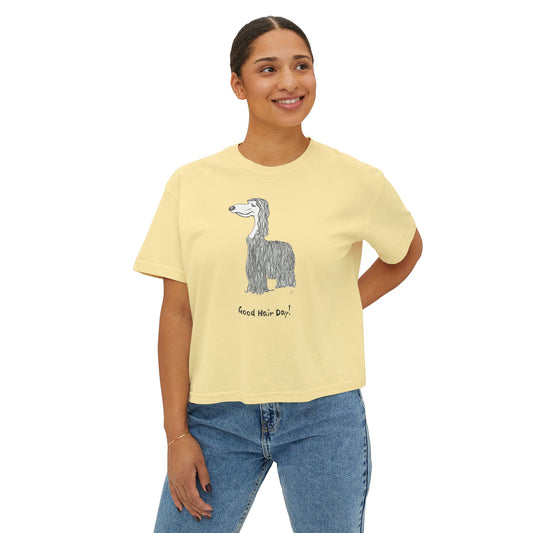 Front of butter yellow boxy Comfort Colors tee worn by a woman, featuring a graphic of an Afghan Hound and the phrase “Good Hair Day!”