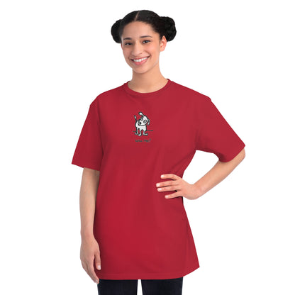Woman in pepper red organic unisex t-shirt featuring a playful, cartoon-style dog with one ear raised and a wagging tail, with the caption “Who Me?” printed below—a fun eco-friendly graphic tee for dog lovers.