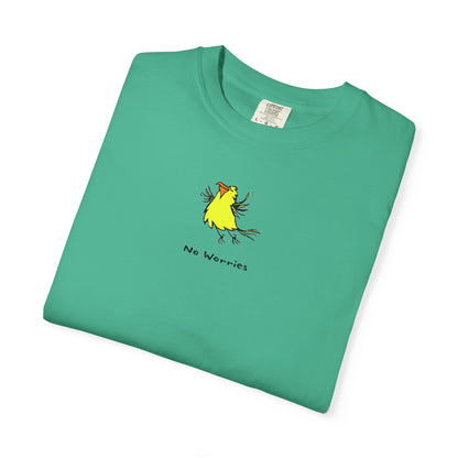 Front of white U.S. Grown cotton Comfort Colors folded t-shirt featuring a small, centered linocut-style illustration of a happy looking flying yellow bird with an orange beak.  Below the artwork is the phrase “No Worries.”