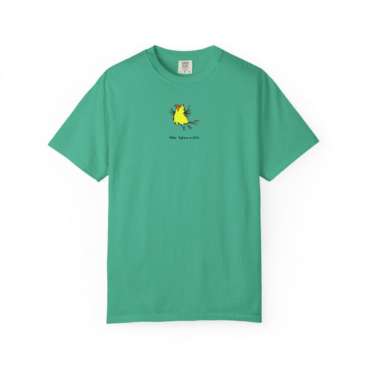 Front of island green U.S. Grown cotton Comfort Colors t-shirt featuring a small, centered linocut-style illustration of a happy looking flying yellow bird with an orange beak.  Below the artwork is the phrase “No Worries.”